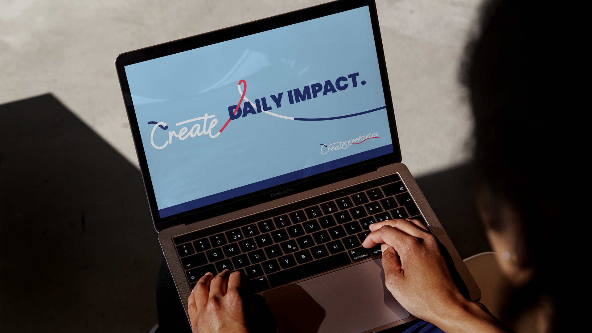 Laptop showing the DFI 'Daily impact' newsletter