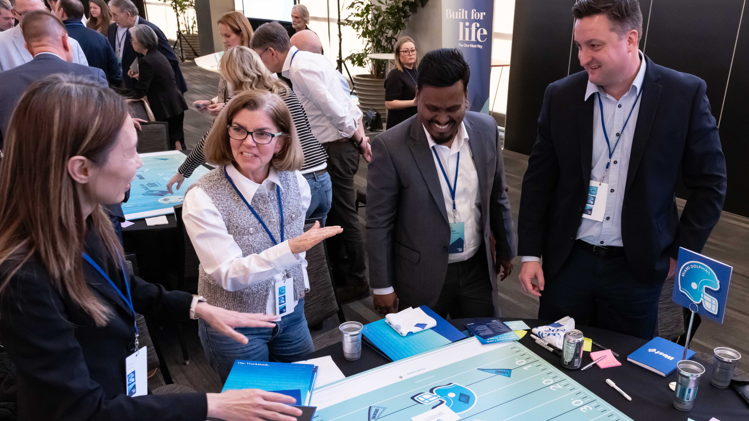 West conference attendees talking around an interactive table